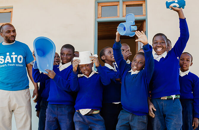 Children with the donated SATO toilets