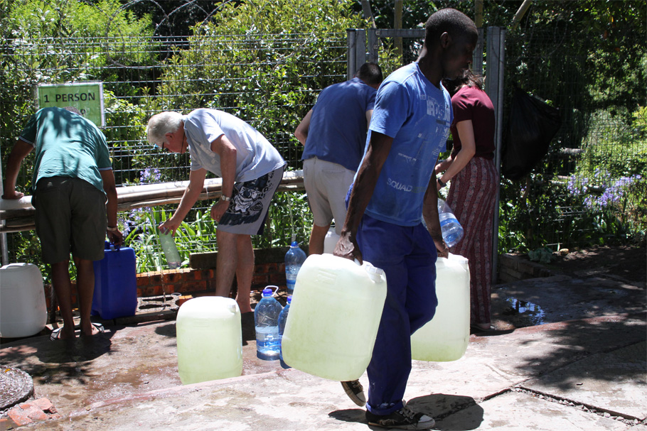 Residents filling up 25 liter containers at a natural spring in Cape Town
